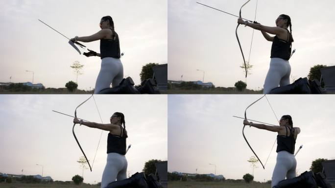近距离观看在靶场练习射箭的迷人亚洲女性。