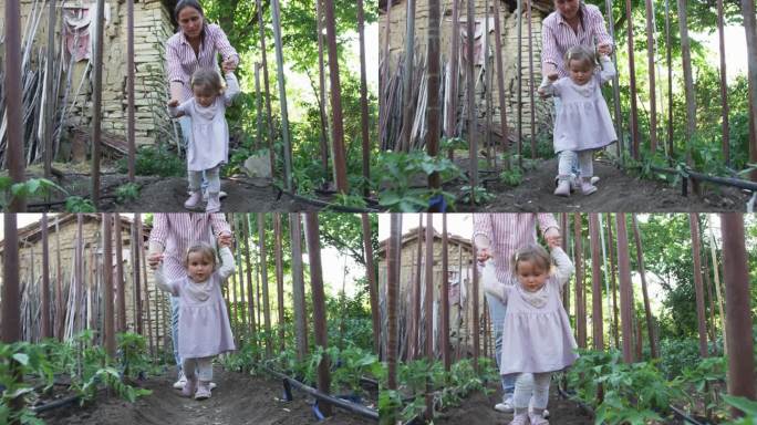母亲和婴儿在菜园里，一起园艺。