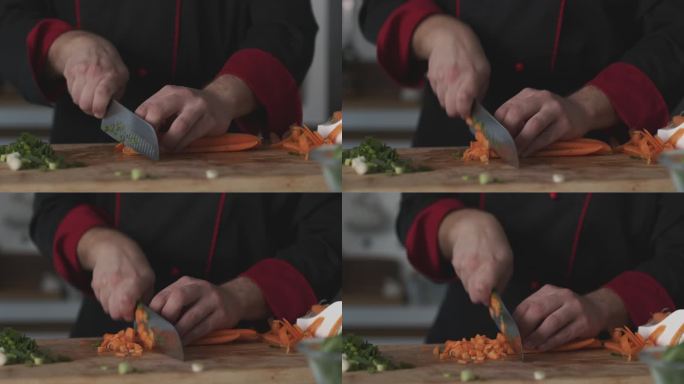 熟练的厨师为他正在准备的一道菜精细地切割胡萝卜