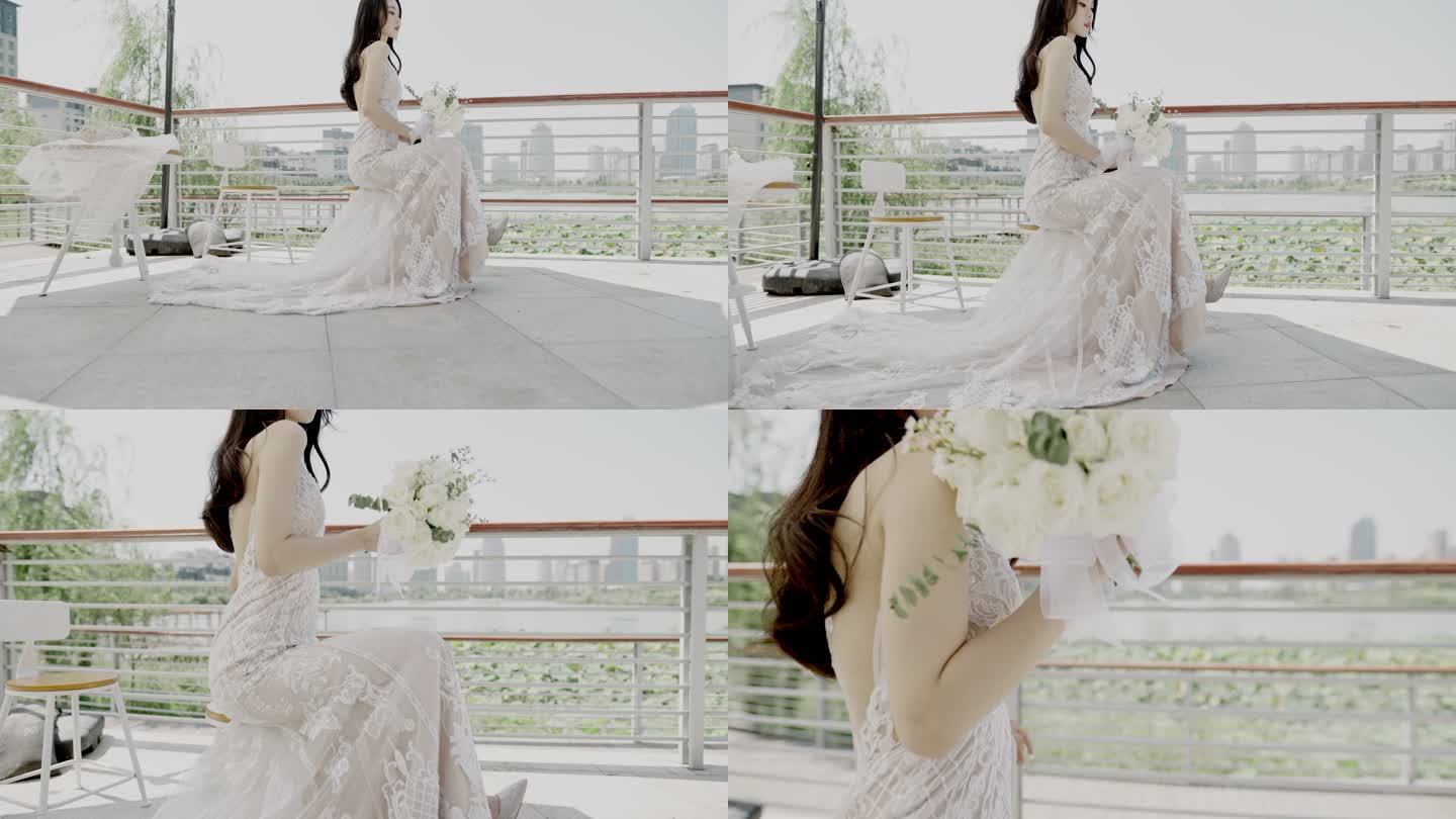 在婚礼现场，一位美丽的亚洲年轻女子身着婚纱，手持一束鲜花，坐在遮阳伞下