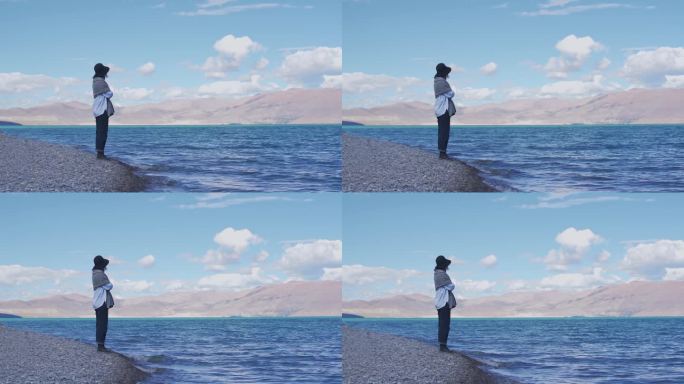 女人站在西藏佩枯错湖岸边