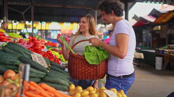 夫妇在公共市场买蔬菜