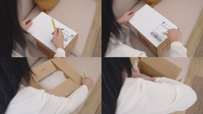 一名亚洲妇女打开包裹，从邮件中发货，打开新的纸箱，在网上购物，然后坐在家里。