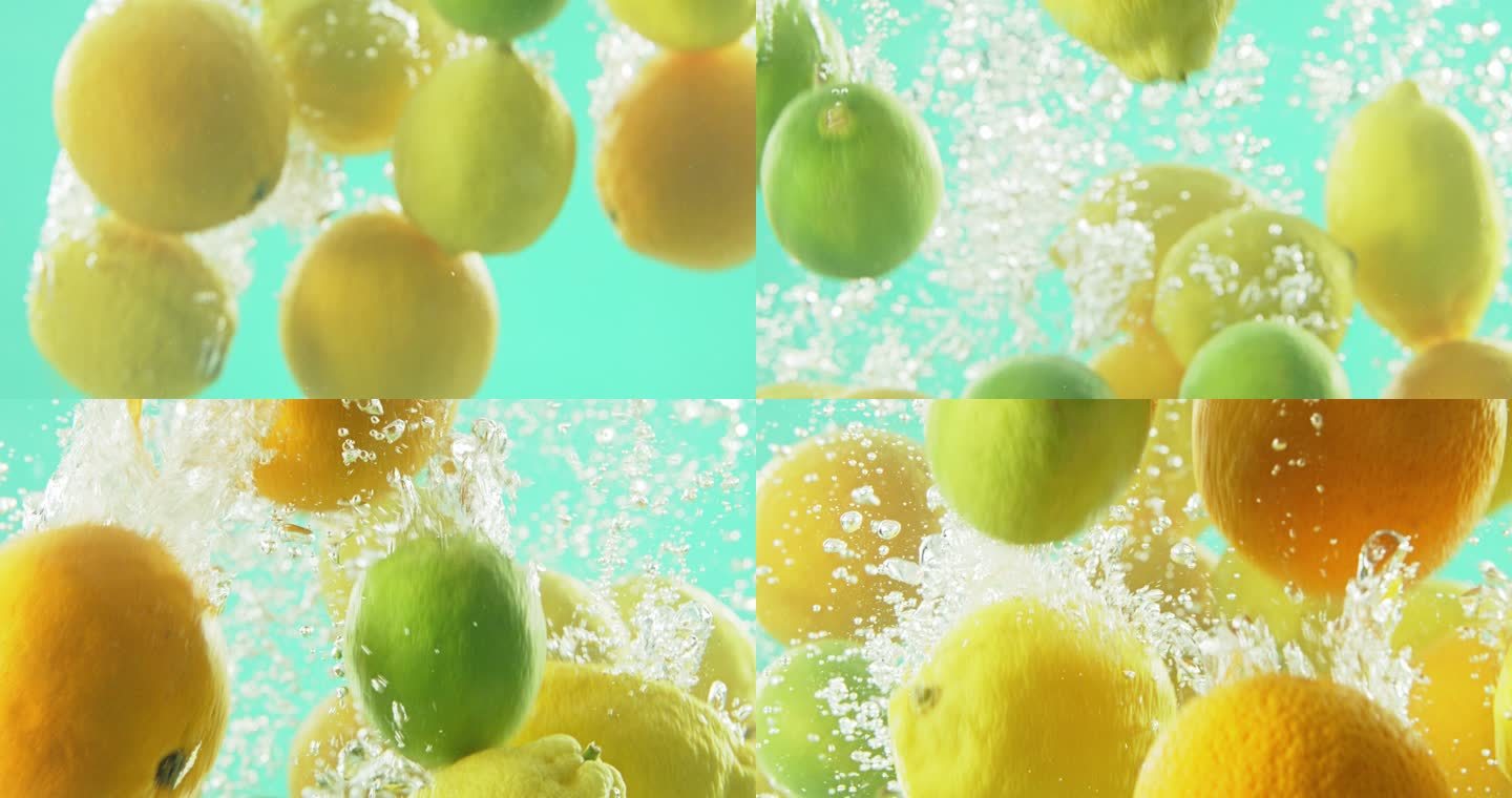 维生素C有助于免疫系统和排毒健康。柠檬和酸橙在蓝色的工作室背景下落入水池中。多汁、健康、成熟的水果漂