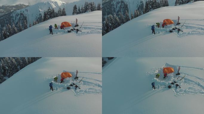 一组滑雪者在雪山帐篷周围的空中无人机拍摄
