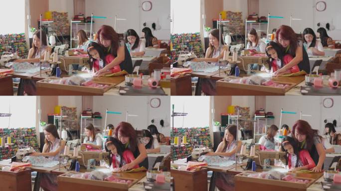 亚洲中国熟女裁缝在工作室用缝纫机教授缝纫技能