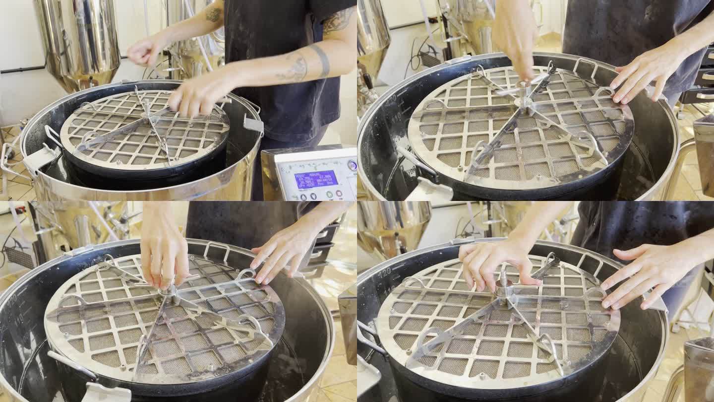 酿酒大师将盖子插入自动壶中，用于精酿啤酒生产。