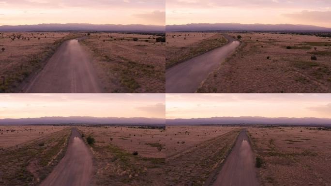 汽车驶入沙漠日落：新墨西哥州