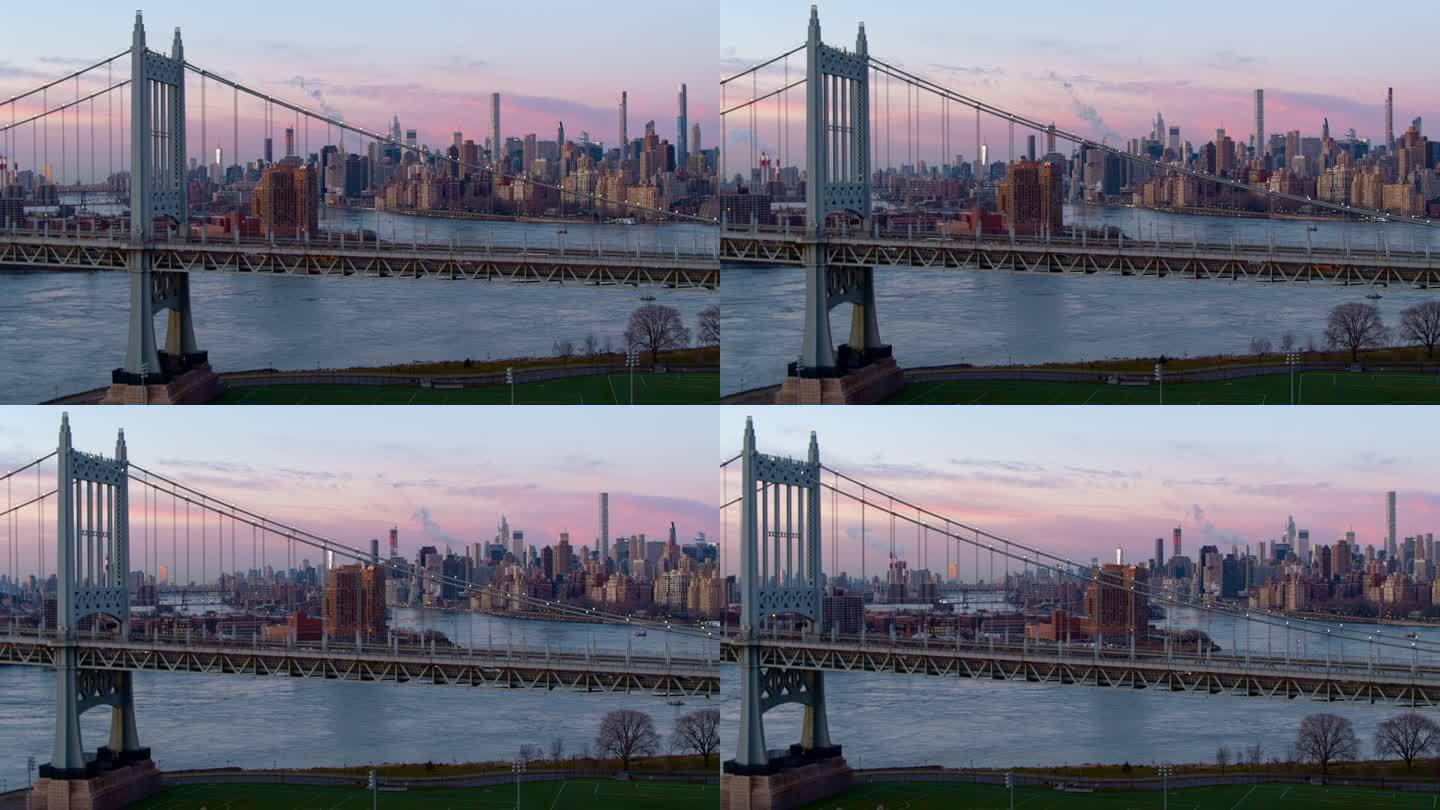 在罗伯特·F·肯尼迪大桥上方的曼哈顿中城天际线上日出，可以看到昆斯博罗大桥、罗斯福岛和上东区。空中无