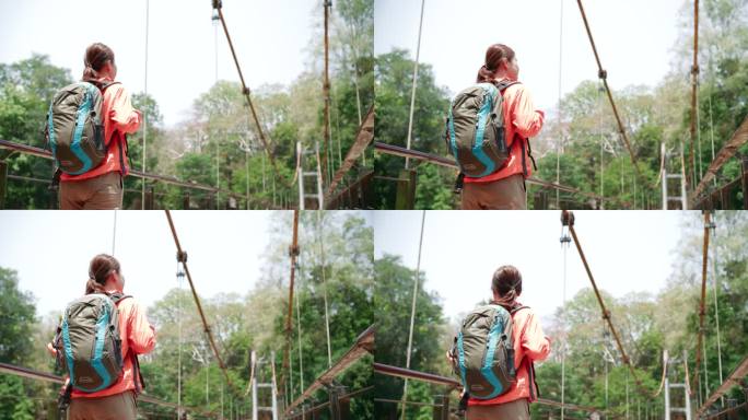 一名年轻女子在树林中穿过一座木制吊桥