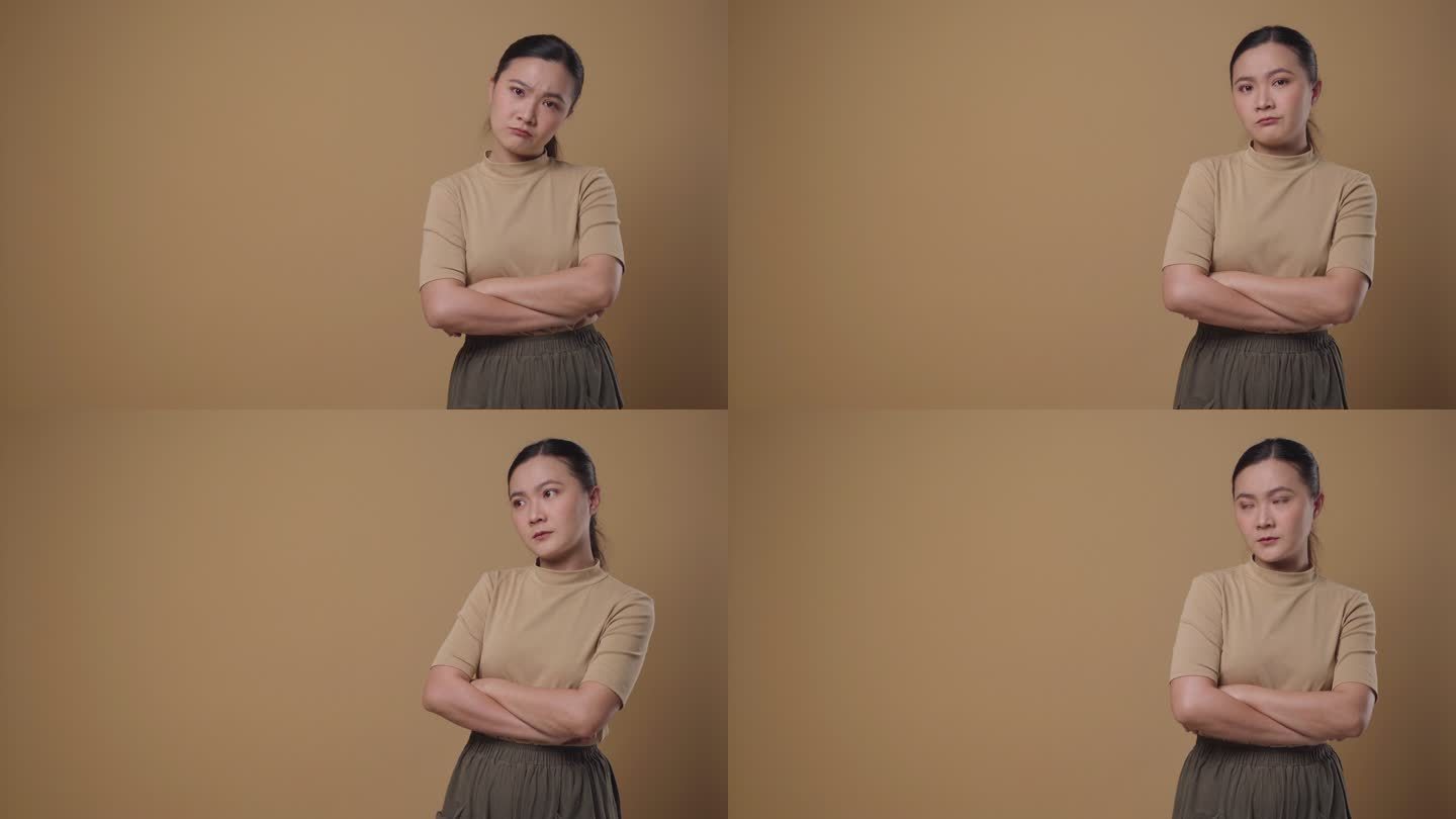 一位亚洲女性看着被隔离在背景上的摄像头感到困惑。4K视频。情感概念。