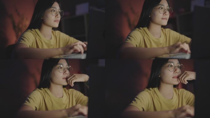 一名亚洲妇女在深夜工作，使用便携式设备，从设备屏幕上近距离观察眼镜的反射