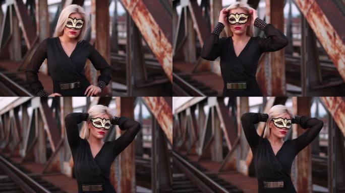 铁路桥上戴着狂欢面具的年轻女子