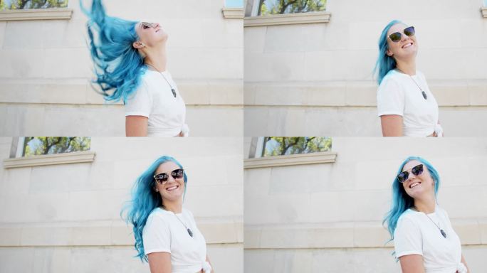 一位独特、活泼、时尚、快乐、快乐的年轻女性在夏天站在室外，可爱的青绿色染发