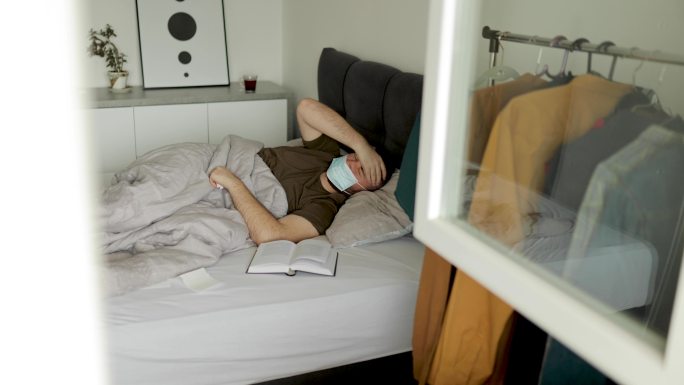 年轻人戴着污染口罩睡觉