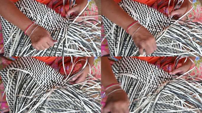 妇女编织干叶的特写手，用于编织篮子，手工制作篮子