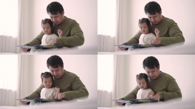 父亲在家照顾女儿读儿童绘本
