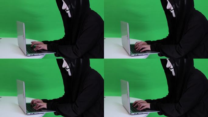 戴面具的黑客键盘打字绿幕视频素材