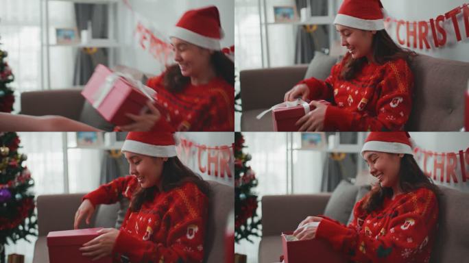 快乐的女人在圣诞节打开礼物盒