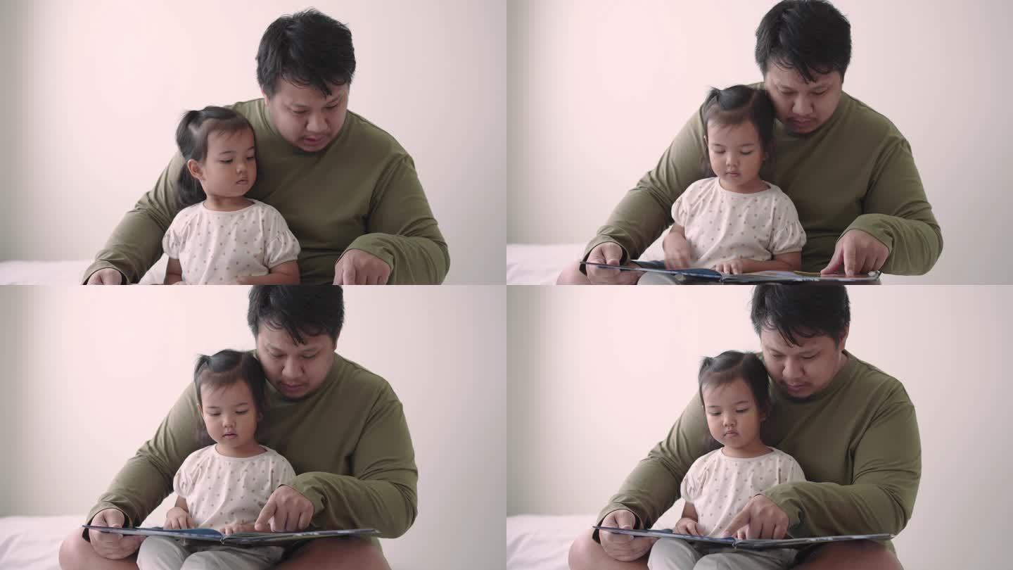 父亲在家照顾女儿读儿童绘本