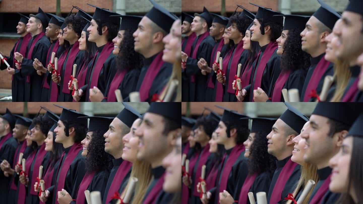 拉丁美洲一群大学毕业的人站成一排，面带微笑