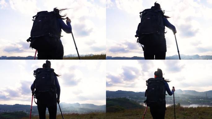 女孩背着背包正在登山爬山向着山顶徒步前进