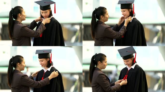 美丽的笑脸毕业的学生女孩年轻的女人和她的妈妈穿着鸭舌帽礼服准备毕业典礼。
