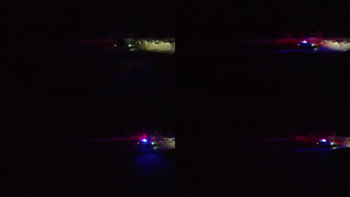 航拍在夜晚土路行驶的警车