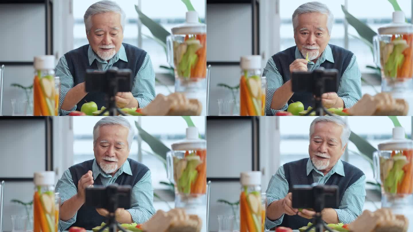 亚洲老年男性vlog在手机上教授烹饪。男老人vlogs，老厨师在手机上录制了一段视频教程，内容是如何