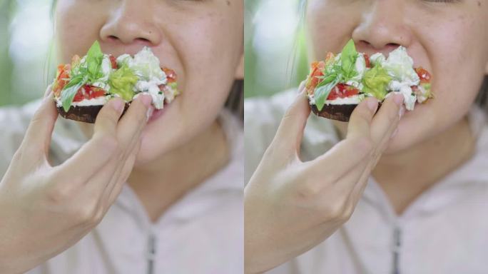 亚洲女性吃纯素肉豆蔻的垂直镜头