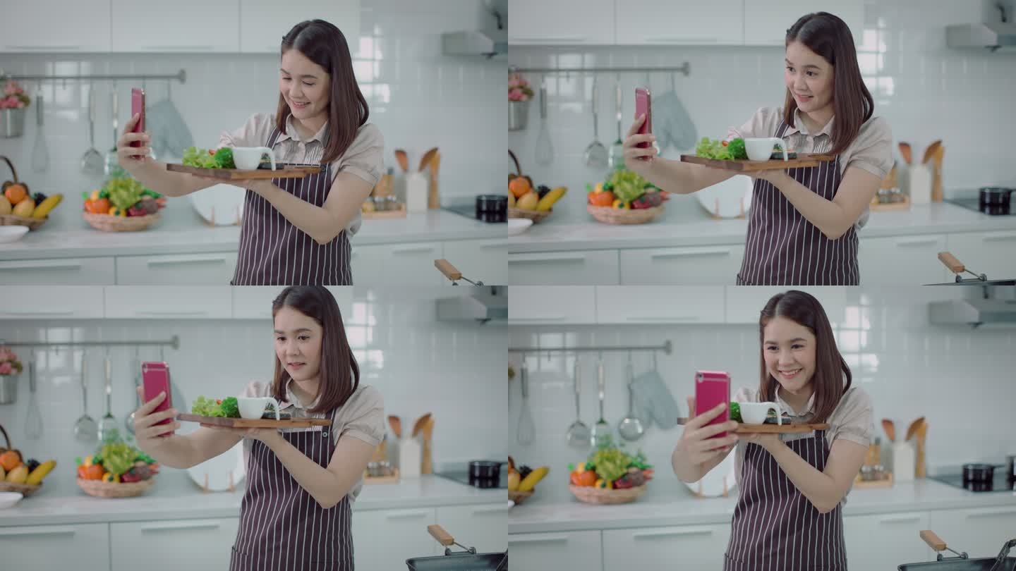 美女直播和自拍三文鱼蔬菜沙拉通过社交媒体，看起来很幸福-生活方式健康饮食，健康生活方式。4K分辨率，