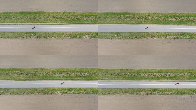 在乡间小路上跑步俯瞰顶视图农村公路一人跑