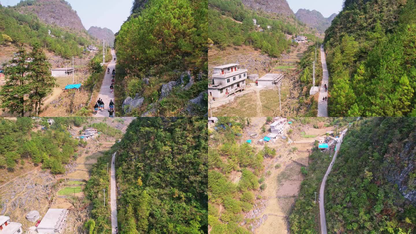 广西白裤瑶原住民山路骑摩托车和走路背影