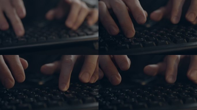 一名男子在黑色电脑键盘上打字