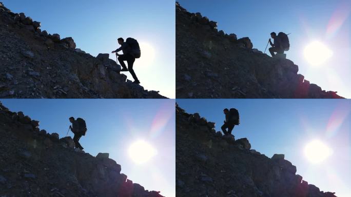 男人背着登山包逆光登山剪影攀登者攀登高峰