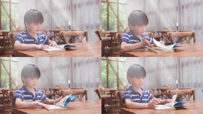 亚洲小男孩在图书馆看书