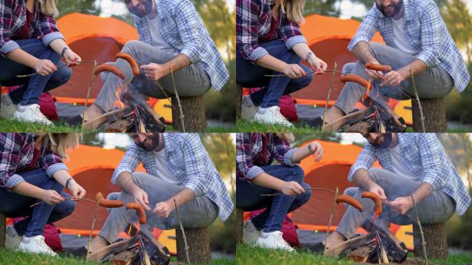 夫妇在篝火上烤香肠