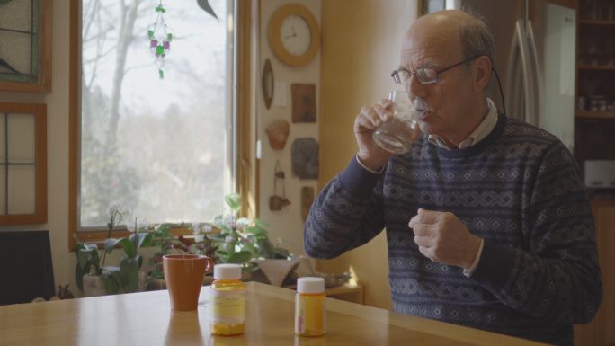 中年男子服用处方药的中镜头