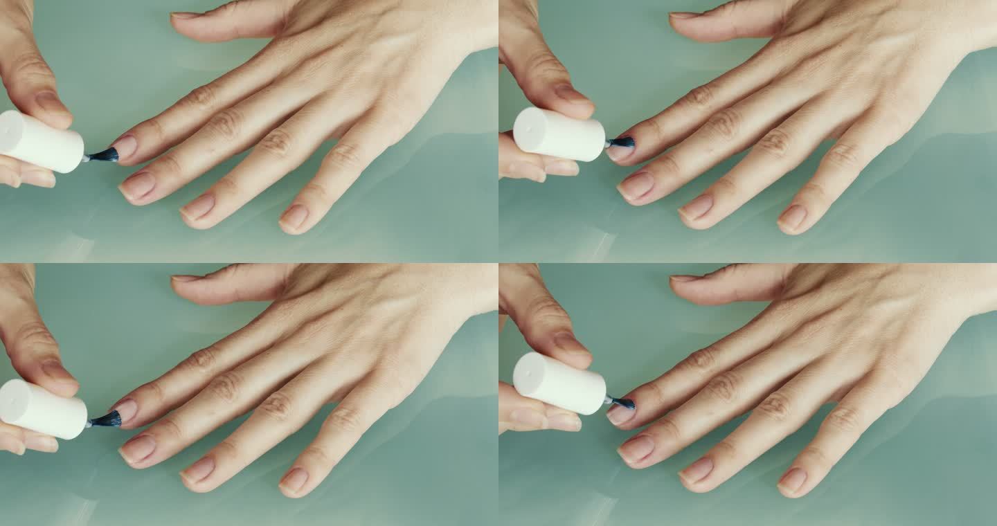 一个女人用清漆涂指甲。
