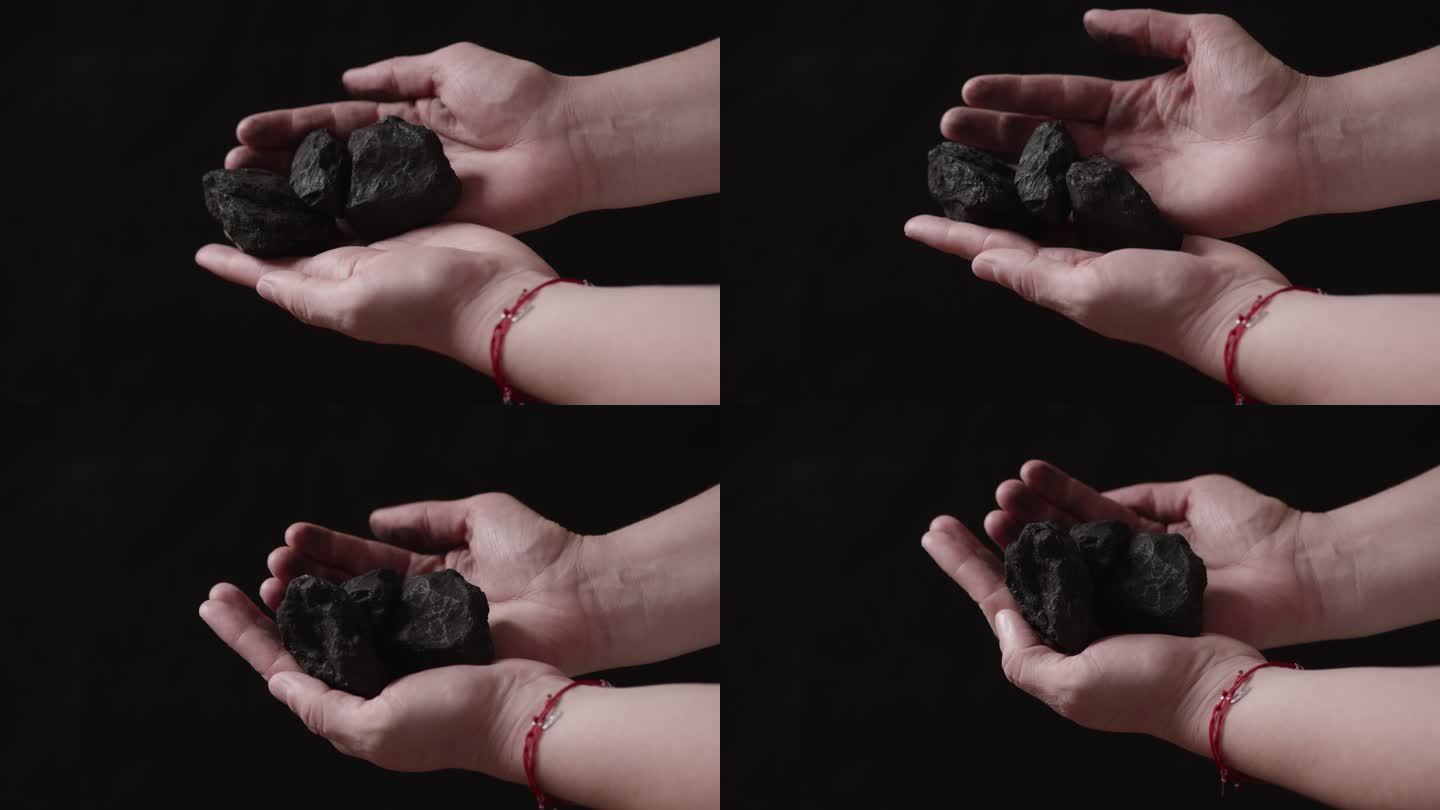 手上的煤块手中煤矿能源危机黑色背景