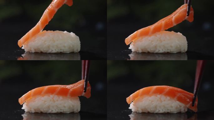 筷子夹起三文鱼片放在米饭上