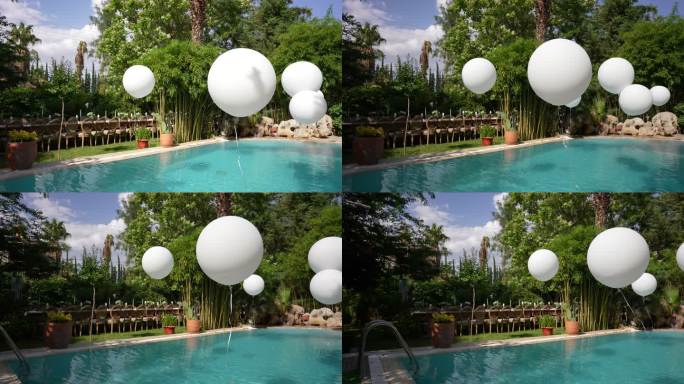 室外有白色大气球的游泳池。池畔派对。水上的气球。