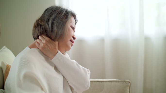 亚洲高级女性按摩治疗师她的颈部减轻疼痛