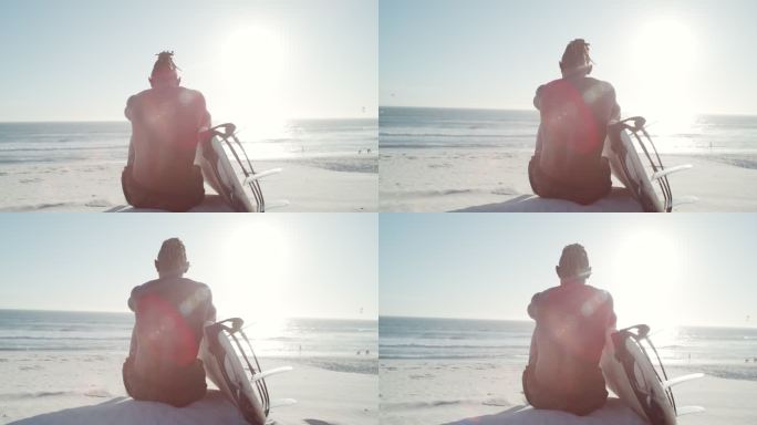 一位面目全非的年轻男性冲浪者坐在沙滩上冲浪板的4k视频片段