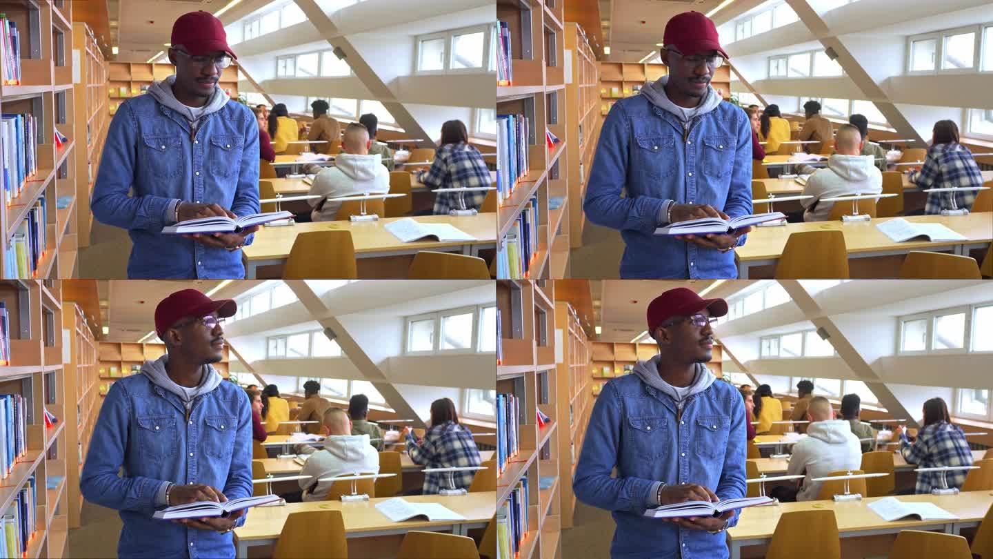一名男学生拿着一本书，向远处吹气