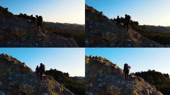 团队登山男人背着登山包爬山攀登顶峰旅行者