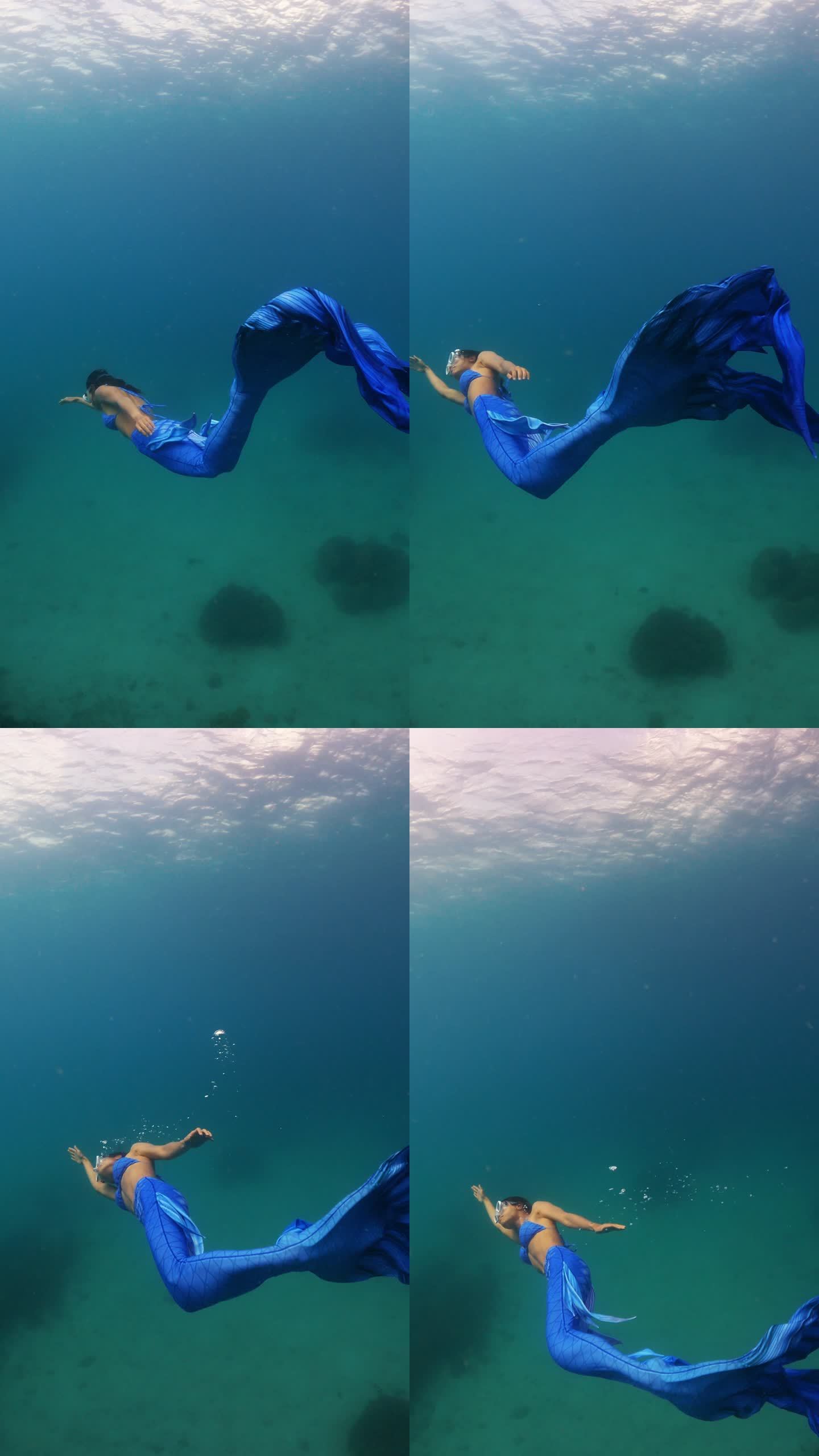 身穿美人鱼裙的亚洲女性在清澈的海水中潜水