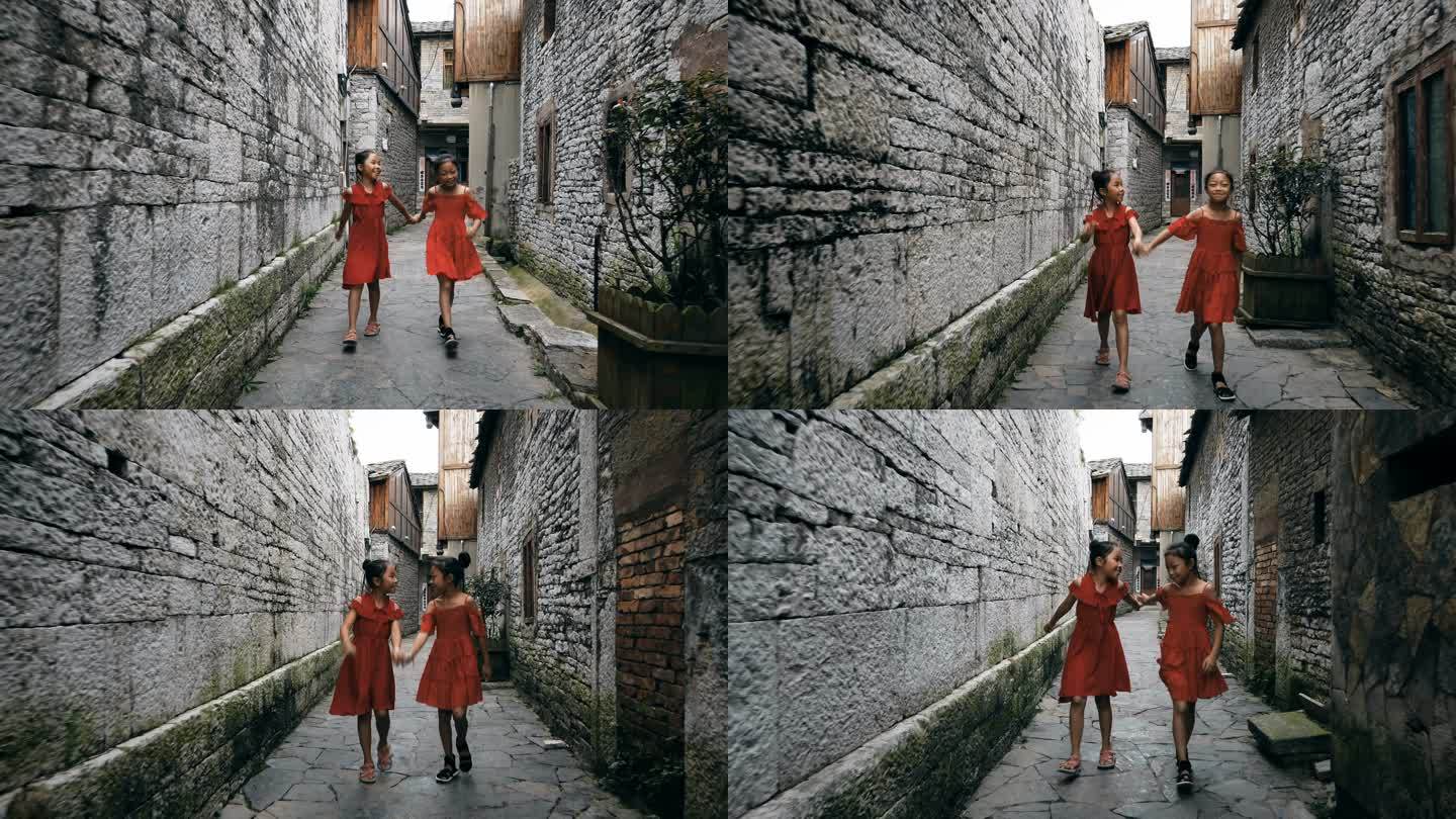 中国贵州安顺，小女孩在一条老巷子里散步。