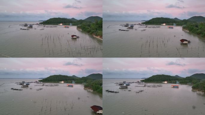 泰国宋赫拉省日落时分，空中无人机在宋赫拉湖上空带着捕鱼设备和养鱼