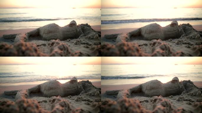 海滩上用沙子做成的美人鱼。雕塑家和他的行为